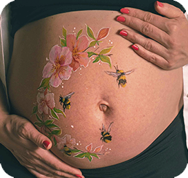 Belly painting with flowers and bees